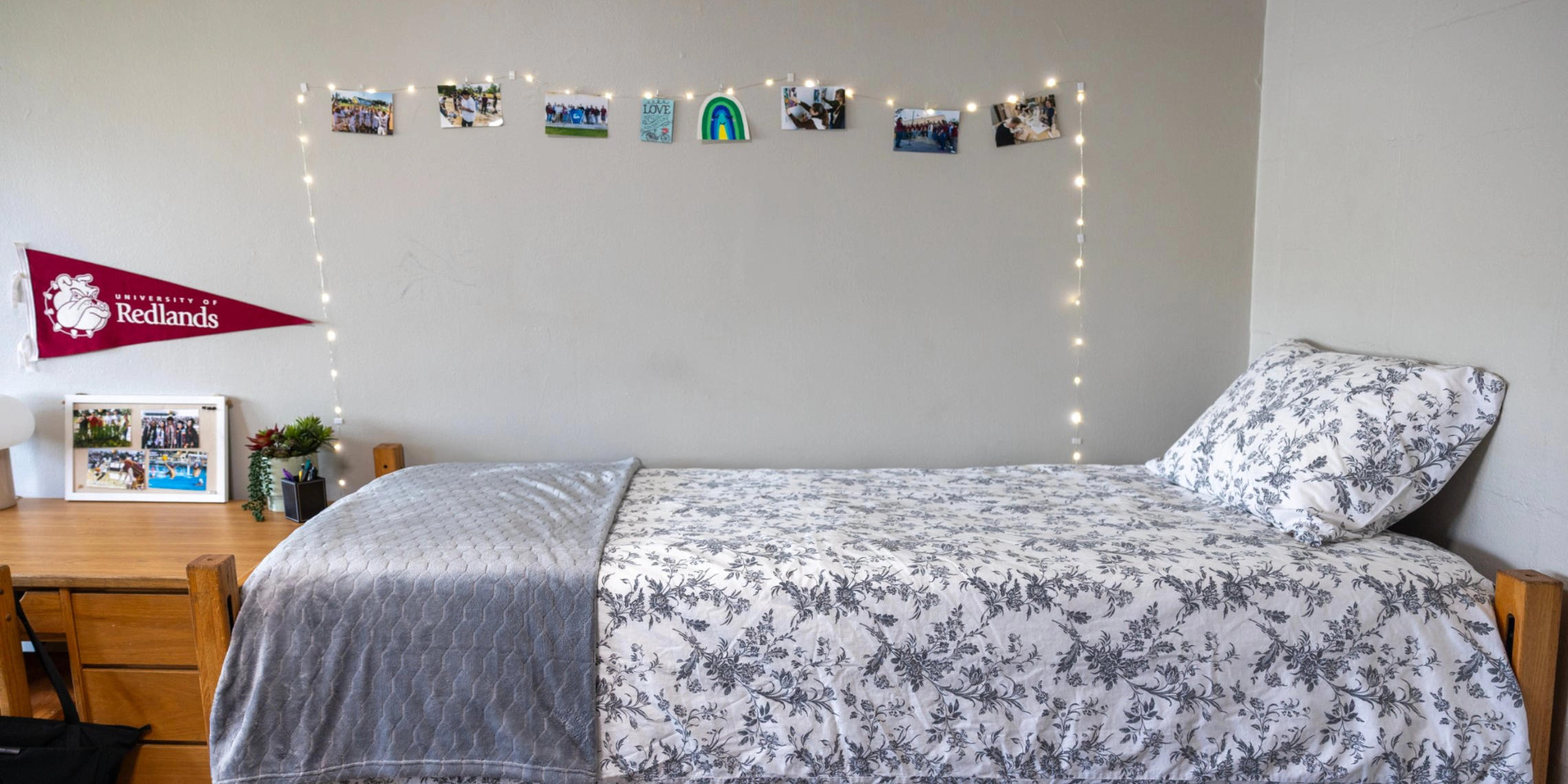 a bed with a blanket and a string of lights