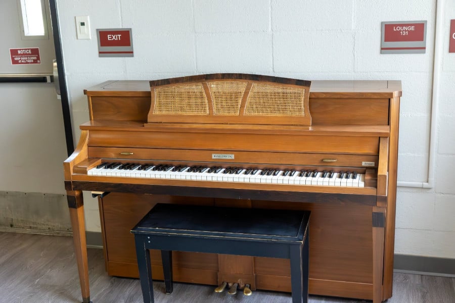a piano with a bench in front of it