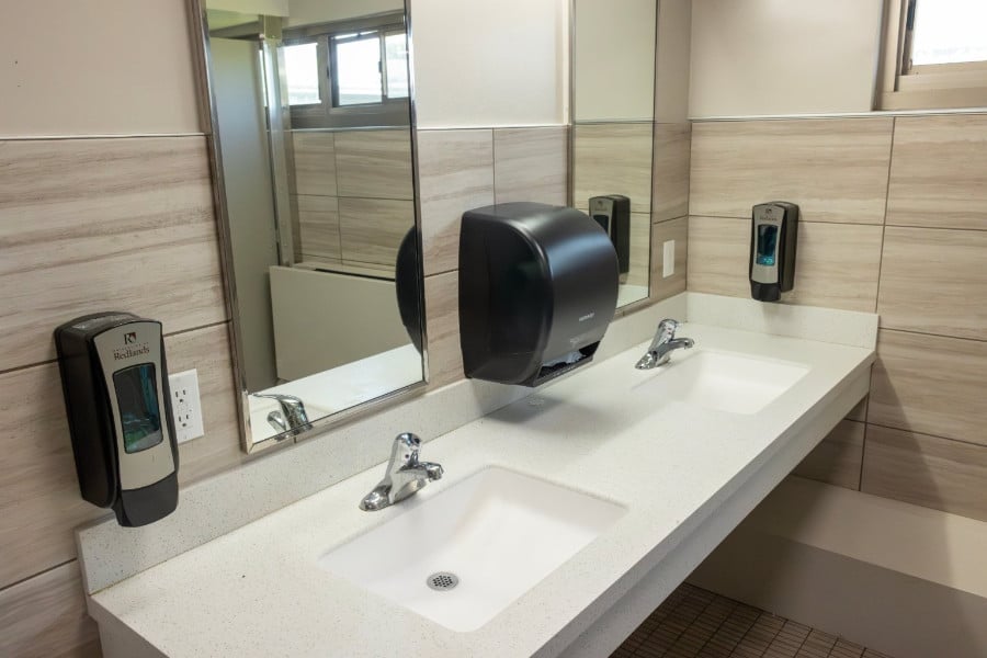 a bathroom with a mirror and a hand dryer