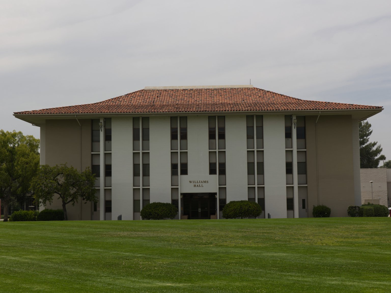 a building with a lawn and trees