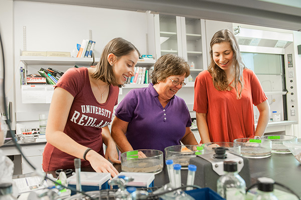students-learning-with-faculty-in-science-lab