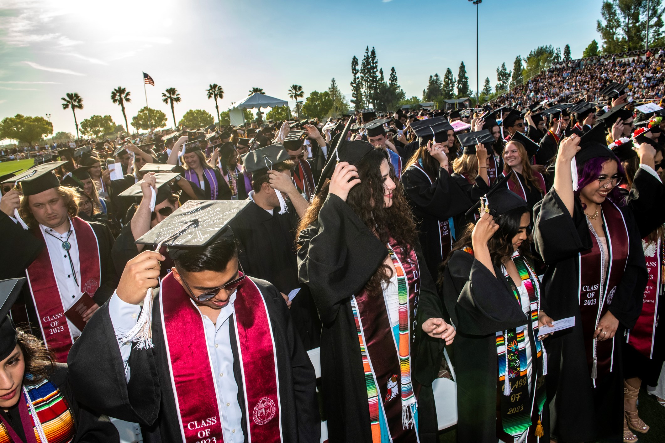 Students celebrate their hard work during Commencement. They prepare to move their tassel from one side to the other, indicating the earning of their diploma. 