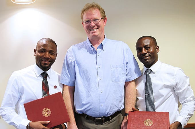 Haitian scholars Professor Herns Celestin (left), Professor Eudras Ceus (right) and Dean Andrew Wall (center).