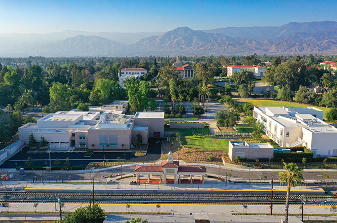 An aerial view of the new U of R train station, with mountains in the background.