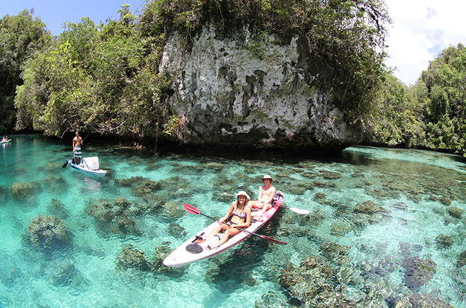 Students kayak in the clear waters of Palau