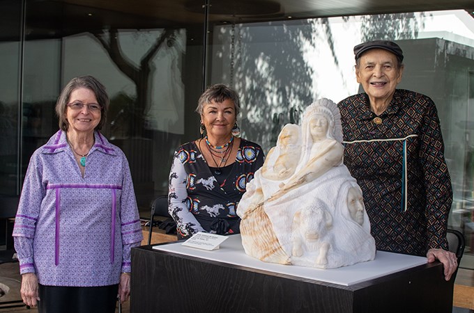 Artist Kathy Whitman Elk Woman (center) unveils the commissioned "Honor the Treaties" sculpture alongside Wayne Mitchell '60 (right) and his wife, Marie Mitchell,  at the Heard Museum in Phoenix, Arizona. (Photo by Heard Museum/Melissa Malork)  