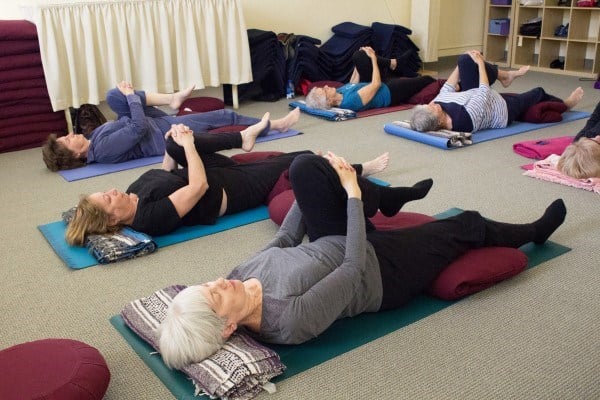 Community members practice Restorative Yoga, led by Pat Geary.