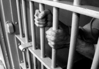 hands gripping prison bars, juvenile justice
