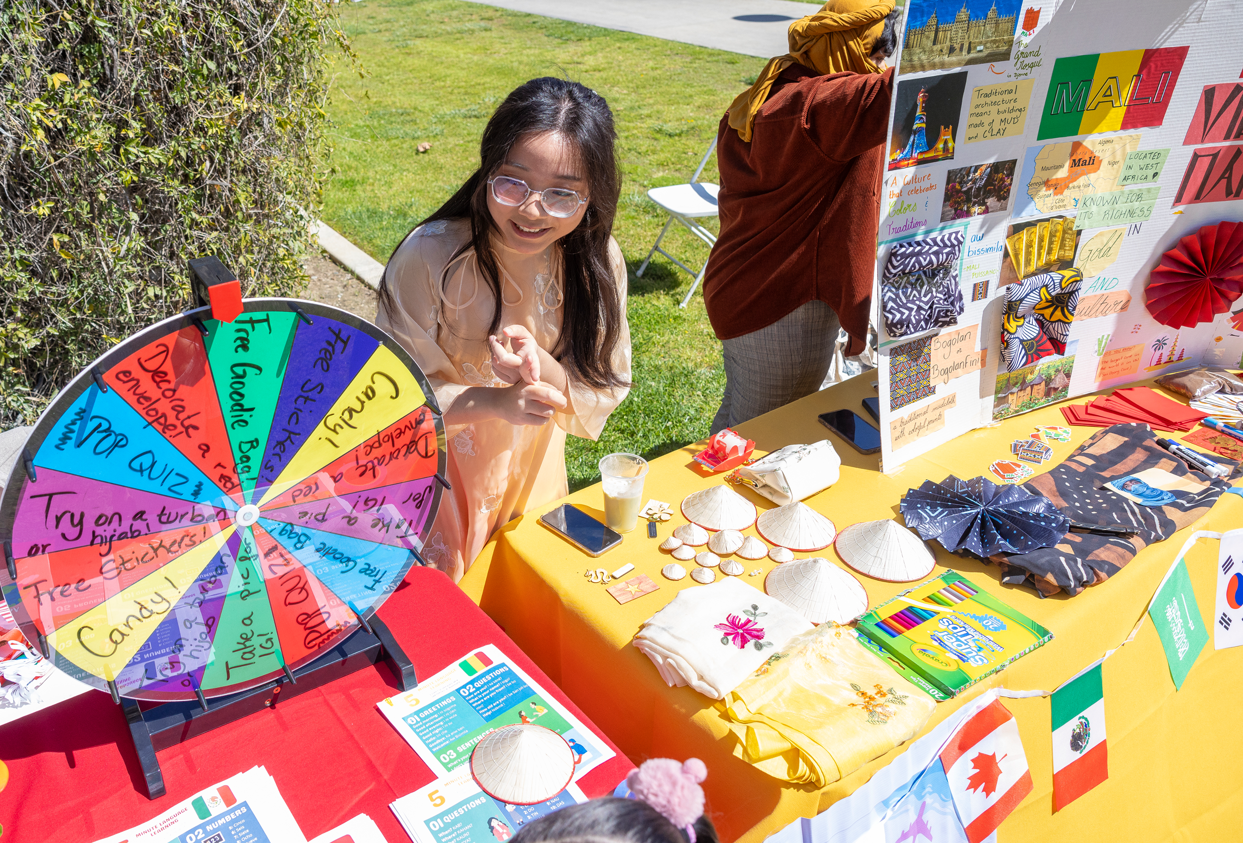 a person standing in front of a table with a wheel of paper and other items