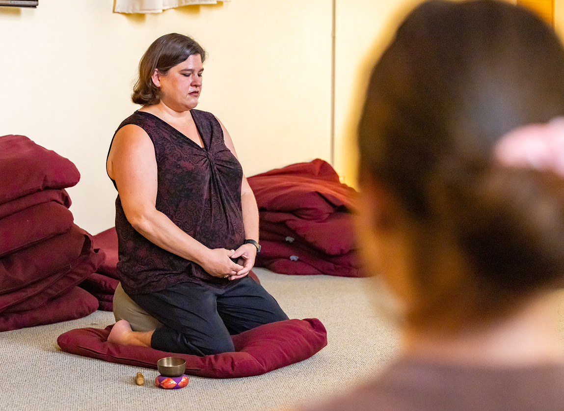 a woman sitting on a pillow