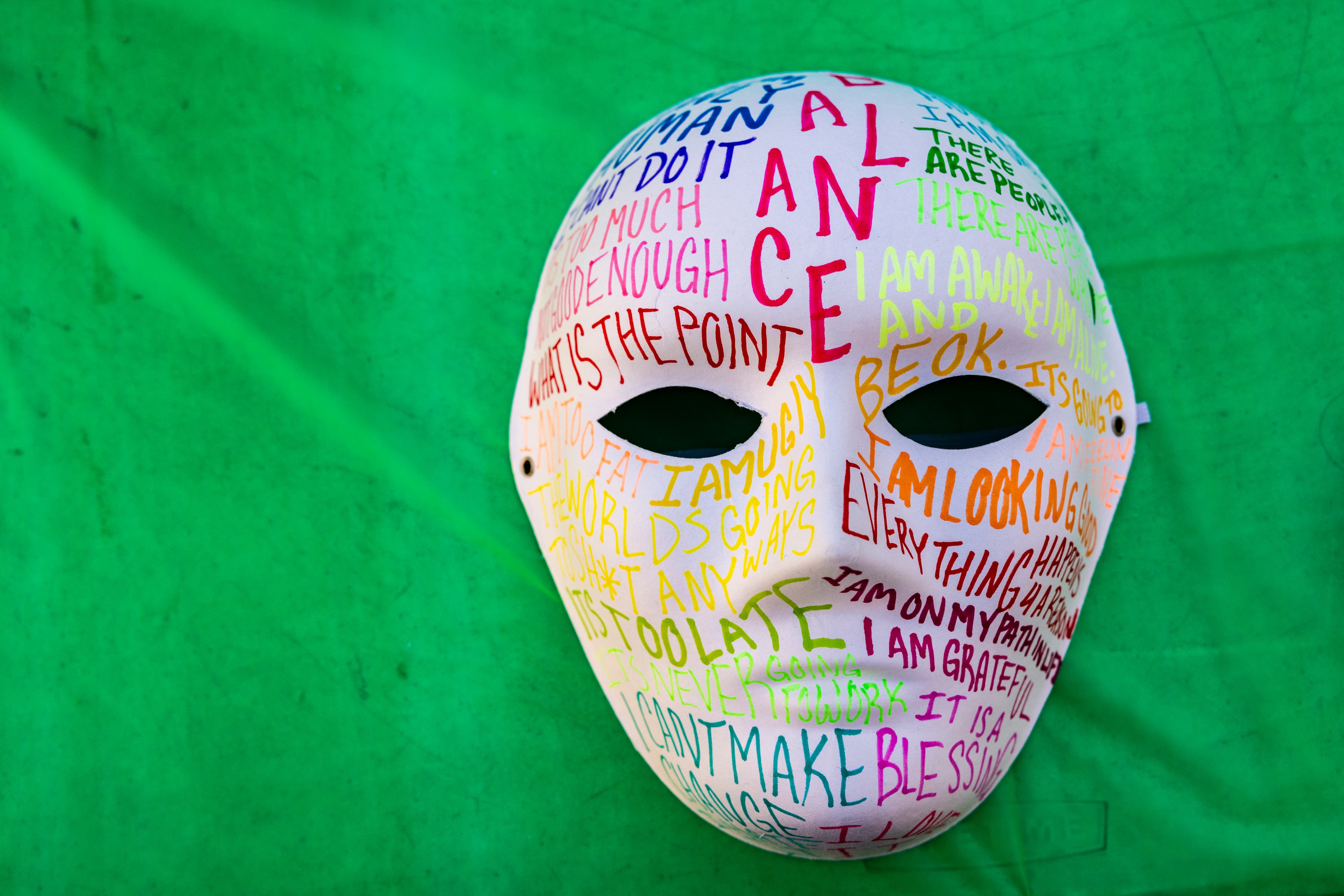 a white mask with writing on it