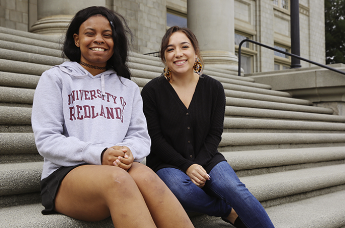 two women sitting on steps