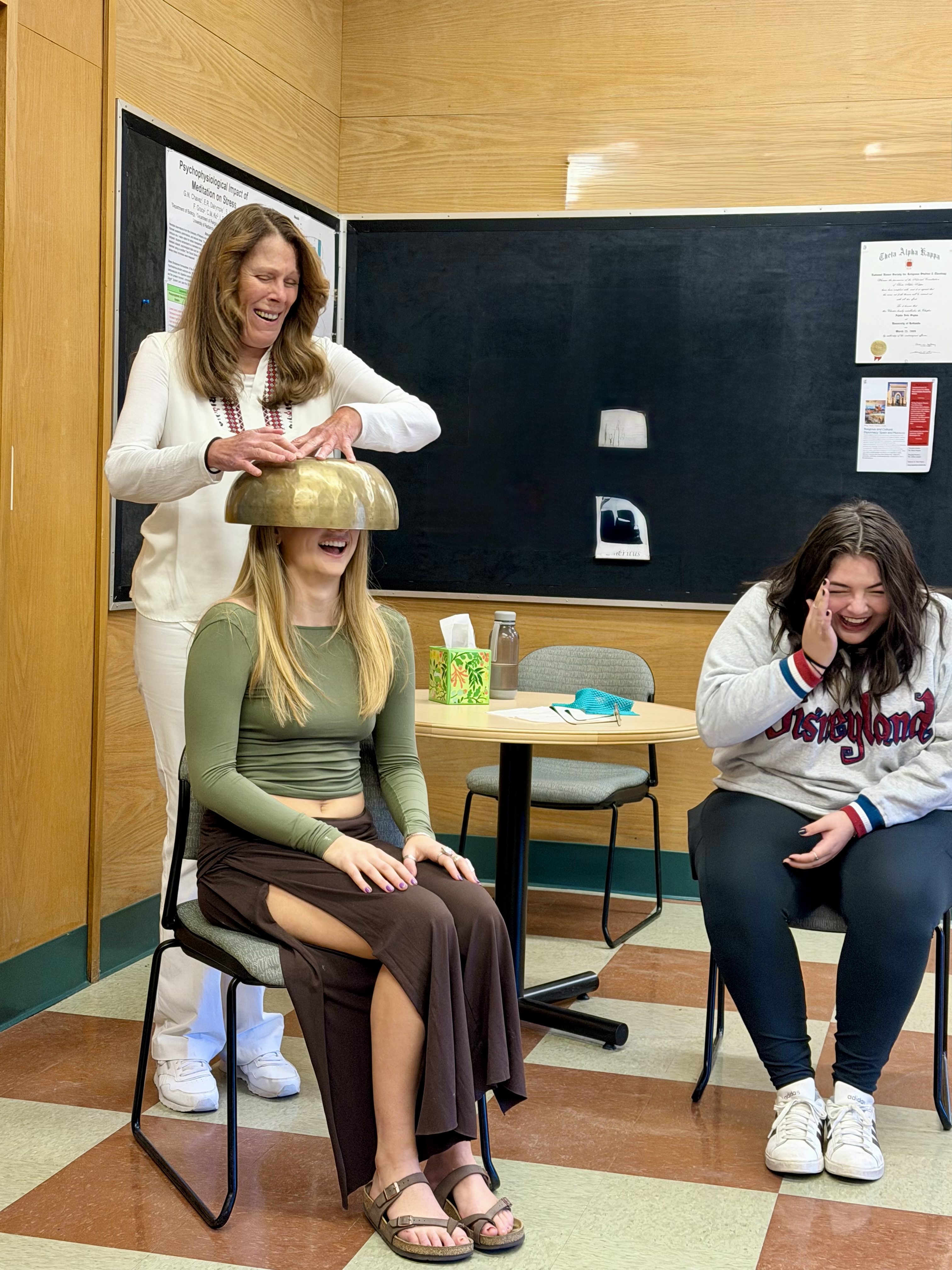 a woman washing a bowl on a woman's head