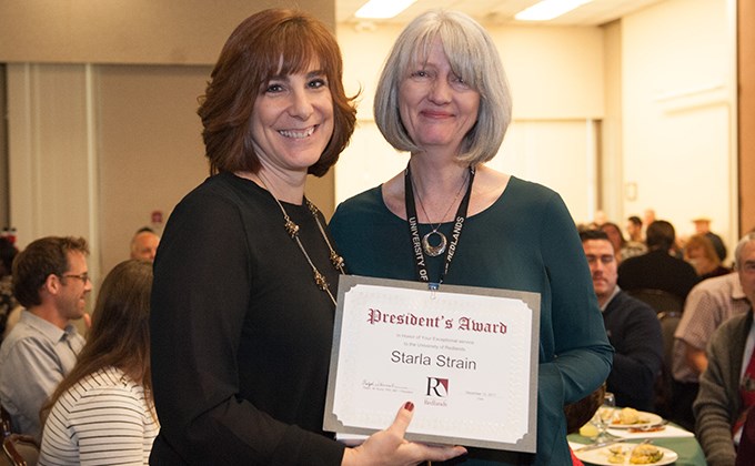 Michelle Rogers giving Starla Strain a President's Award