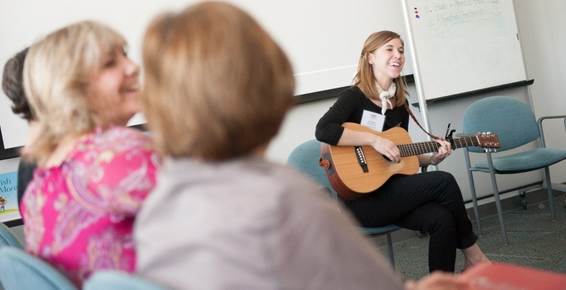 Emily Arrow, a musician who writes songs inspired by children's literature, teaches participants to incorporate music into story time during the 20th annual Charlotte S. Huck Children's Literature Festival.