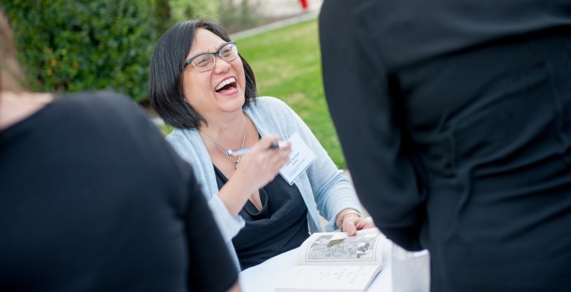 Award-winning author Linda Sue Park laughs with guests during a book signing at the University of Redlands 20th annual Charlotte S. Huck Children's Literature Festival.